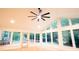 Sunroom with a wall of bright windows, hardwood floors, and a ceiling fan at 3204 Manor Ridge Dr, Raleigh, NC 27603