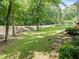 Expansive lawn and mature trees create a private yard space at 3204 Manor Ridge Dr, Raleigh, NC 27603
