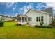 Spacious lawn features a patio with a white lounge chair, screened-in porch, and lush green landscaping at 328 Boone St, Chapel Hill, NC 27516