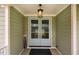 Stylish light blue front door with glass panels and an overhead light fixture for a welcoming entrance at 328 Boone St, Chapel Hill, NC 27516