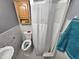 Bathroom featuring tiled walls, white shower curtain, toilet, and corner cabinet at 3612 Satellite Ct, Raleigh, NC 27604
