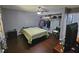 Bedroom with hardwood floors, ceiling fan, TV, closet, and doorway to the bathroom at 3612 Satellite Ct, Raleigh, NC 27604