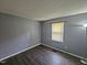 Neutral bedroom featuring wood-look flooring and a window with blinds at 3612 Satellite Ct, Raleigh, NC 27604