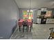 Dining area with white tile floors, stylish light fixture, and sliding doors to the backyard at 3612 Satellite Ct, Raleigh, NC 27604