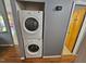 Convenient laundry area with stacked washer and dryer and hardwood floors at 3612 Satellite Ct, Raleigh, NC 27604