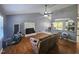 Cozy living room with fireplace, hardwood floors, and ceiling fan, open to the kitchen at 3612 Satellite Ct, Raleigh, NC 27604