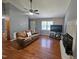Comfortable living room showcasing hardwood floors, a fireplace, ceiling fan and neutral paint at 3612 Satellite Ct, Raleigh, NC 27604