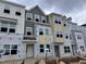 New construction townhomes featuring multiple stories and large windows awaiting final touches at 368 Chesapeak Commons St # 132, Garner, NC 27529