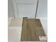 Sample of white cabinets, light backsplash and luxury vinyl plank flooring at 368 Chesapeak Commons St # 132, Garner, NC 27529