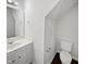 Bathroom features a vanity with sink, mirror, and toilet, maximizing functionality in a compact space at 3708 Mackinac Island Ln, Raleigh, NC 27610