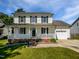 Charming two-story home featuring a welcoming front porch, attached garage, and well-maintained lawn at 3708 Mackinac Island Ln, Raleigh, NC 27610