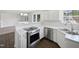 Modern kitchen featuring stainless steel appliances, white countertops, and ample cabinet space at 3708 Mackinac Island Ln, Raleigh, NC 27610