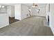 Spacious living room featuring neutral carpet, and a fireplace creating an inviting and comfortable atmosphere at 3708 Mackinac Island Ln, Raleigh, NC 27610