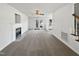 A spacious living room featuring neutral carpet, a fireplace, and glass doors leading to the backyard at 3708 Mackinac Island Ln, Raleigh, NC 27610