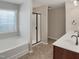 Bathroom with a soaking tub, walk-in shower, and double sink vanity at 3709 Althorp Dr, Raleigh, NC 27616