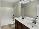 Bathroom featuring a double vanity, a white shower and tub combo, and tile flooring at 3709 Althorp Dr, Raleigh, NC 27616