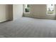 Spacious bedroom with plush carpeting and two bright windows offering natural light at 3709 Althorp Dr, Raleigh, NC 27616