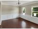 Bright dining room features elegant wainscoting, hardwood floors, and plenty of natural light at 3709 Althorp Dr, Raleigh, NC 27616