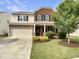 Charming two-story home with a brick and siding exterior, landscaped yard, and attached two-car garage at 3709 Althorp Dr, Raleigh, NC 27616