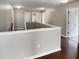 Hallway with hardwood floors, neutral walls, white trim, and doors provides an inviting transition between spaces at 3709 Althorp Dr, Raleigh, NC 27616