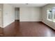 Spacious living room features hardwood floors and large windows, offering plenty of natural light at 3709 Althorp Dr, Raleigh, NC 27616