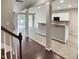 Open-concept living space with hardwood floors and a view of the kitchen and staircase at 3709 Althorp Dr, Raleigh, NC 27616