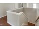A view from the top of the carpeted stairs shows a handrail and neutral paint at 3709 Althorp Dr, Raleigh, NC 27616