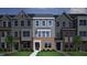 Charming townhome featuring a brick facade, gray siding, and well-manicured lawn at 372 Chesapeak Commons St # 131, Garner, NC 27529