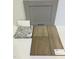 Sample of interior finishes featuring gray cabinet, granite countertop, and wood-look luxury vinyl flooring at 376 Chesapeak Commons St # 130, Garner, NC 27529