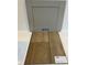 Sample of interior finishes featuring gray cabinet and wood-look luxury vinyl flooring at 376 Chesapeak Commons St # 130, Garner, NC 27529