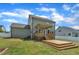 Exterior view showcasing a spacious backyard with a deck and well-maintained lawn at 384 Grey Hawk Dr, Garner, NC 27529