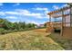 Spacious backyard with a wooden deck and lush greenery for outdoor enjoyment at 384 Grey Hawk Dr, Garner, NC 27529