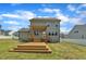 Exterior view featuring a spacious yard, inviting deck, and a well-maintained home, perfect for outdoor enjoyment at 384 Grey Hawk Dr, Garner, NC 27529