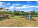 Spacious backyard featuring a playset, deck, and abundant green space, perfect for outdoor activities at 384 Grey Hawk Dr, Garner, NC 27529