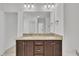 Bathroom vanity featuring granite countertops, double sinks and a large mirror at 384 Grey Hawk Dr, Garner, NC 27529