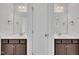 Bathroom with dual sinks and dark wood cabinets, plus a large mirror at 384 Grey Hawk Dr, Garner, NC 27529