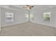 Spacious bedroom with tray ceiling, ceiling fan, and bright natural light at 384 Grey Hawk Dr, Garner, NC 27529
