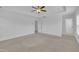 Bedroom featuring neutral carpet, tray ceilings and a view into the bathroom at 384 Grey Hawk Dr, Garner, NC 27529
