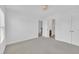 Bright, neutral bedroom featuring carpet flooring and white walls at 384 Grey Hawk Dr, Garner, NC 27529