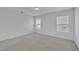 Bedroom with neutral carpet, white walls, and abundant natural light at 384 Grey Hawk Dr, Garner, NC 27529