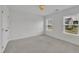 Bedroom with neutral colored carpet and two windows at 384 Grey Hawk Dr, Garner, NC 27529