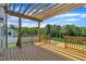 Wooden deck with a pergola, perfect for outdoor relaxation or entertaining while enjoying a beautiful view at 384 Grey Hawk Dr, Garner, NC 27529