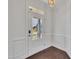 Entryway features white wainscoting, trim, and white glass-paned front door at 384 Grey Hawk Dr, Garner, NC 27529