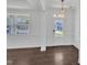 Bright entryway featuring white walls and trim, with dark hardwood floors at 384 Grey Hawk Dr, Garner, NC 27529