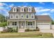Charming two-story home with a welcoming front porch and beautifully landscaped yard at 384 Grey Hawk Dr, Garner, NC 27529