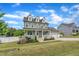 Charming two-story home with a landscaped yard and picket fence at 384 Grey Hawk Dr, Garner, NC 27529