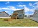 Exterior home showcasing the deck, well-manicured backyard, and lovely curb appeal at 384 Grey Hawk Dr, Garner, NC 27529