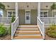 Charming covered front porch and nicely stained entry steps at 384 Grey Hawk Dr, Garner, NC 27529