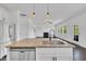 Kitchen island featuring stainless steel dishwasher, granite countertops, and modern fixtures at 384 Grey Hawk Dr, Garner, NC 27529