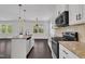 Modern kitchen with stainless steel appliances, granite countertops, and views to the outdoors at 384 Grey Hawk Dr, Garner, NC 27529